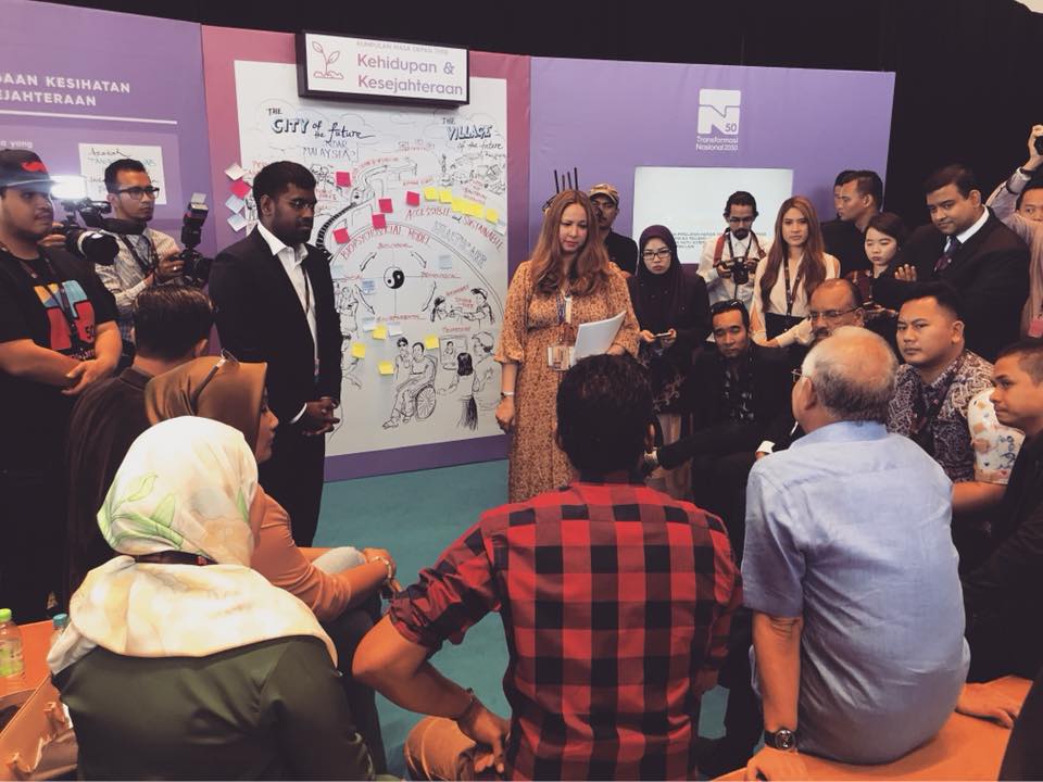 Large community gathering with Orang Asli families celebrating the completion of a Saora+ development project