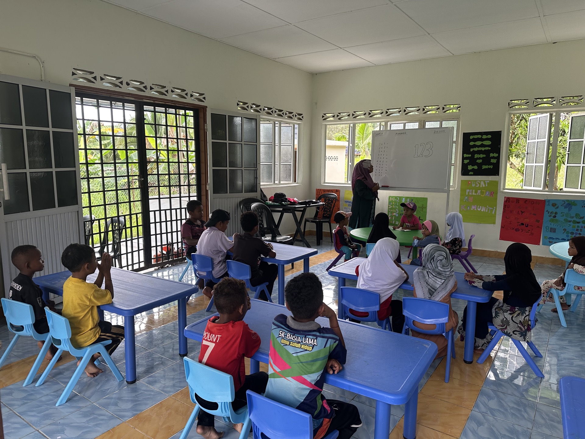 Classroom activities at a Saora+ education centre — children working with educational materials and school supplies