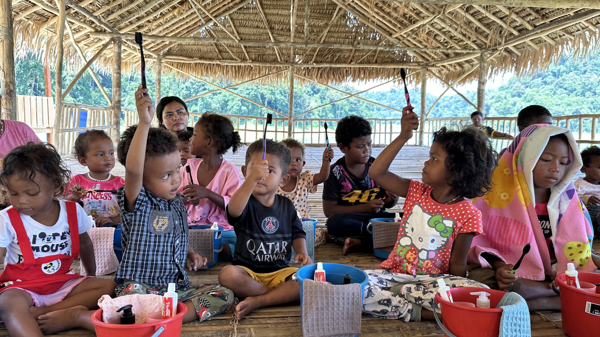 Classroom activities — Orang Asli students engaged in hands-on learning exercises with art supplies and workbooks