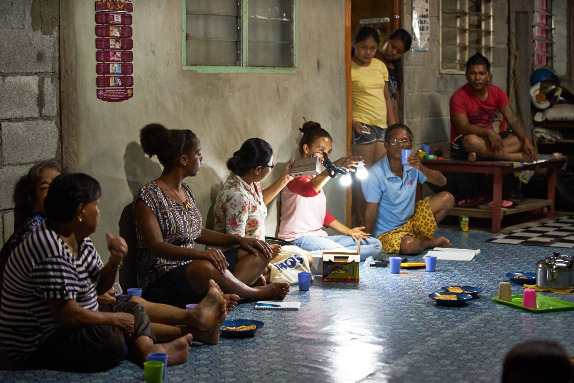Orang Asli community members at the solar-powered communal hall in Kampung Sungai Kelit, enabled by Saora+ renewable energy programme