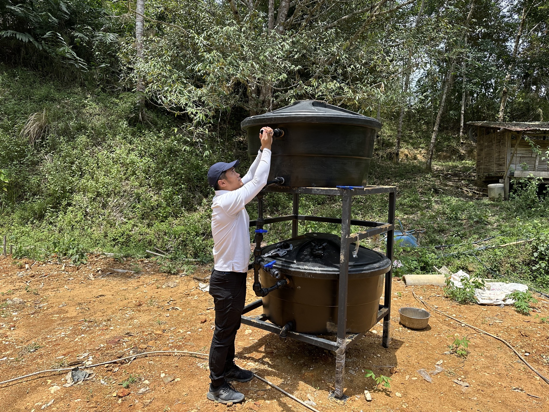 Saora+ clean water infrastructure at Kampung Sungai Raba — gravity-fed water filtration system serving the remote Orang Asli settlement